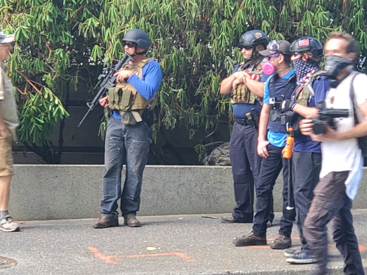 Notice the fellow on the right, carrying a baseball bat and OC spray instead of a rifle.