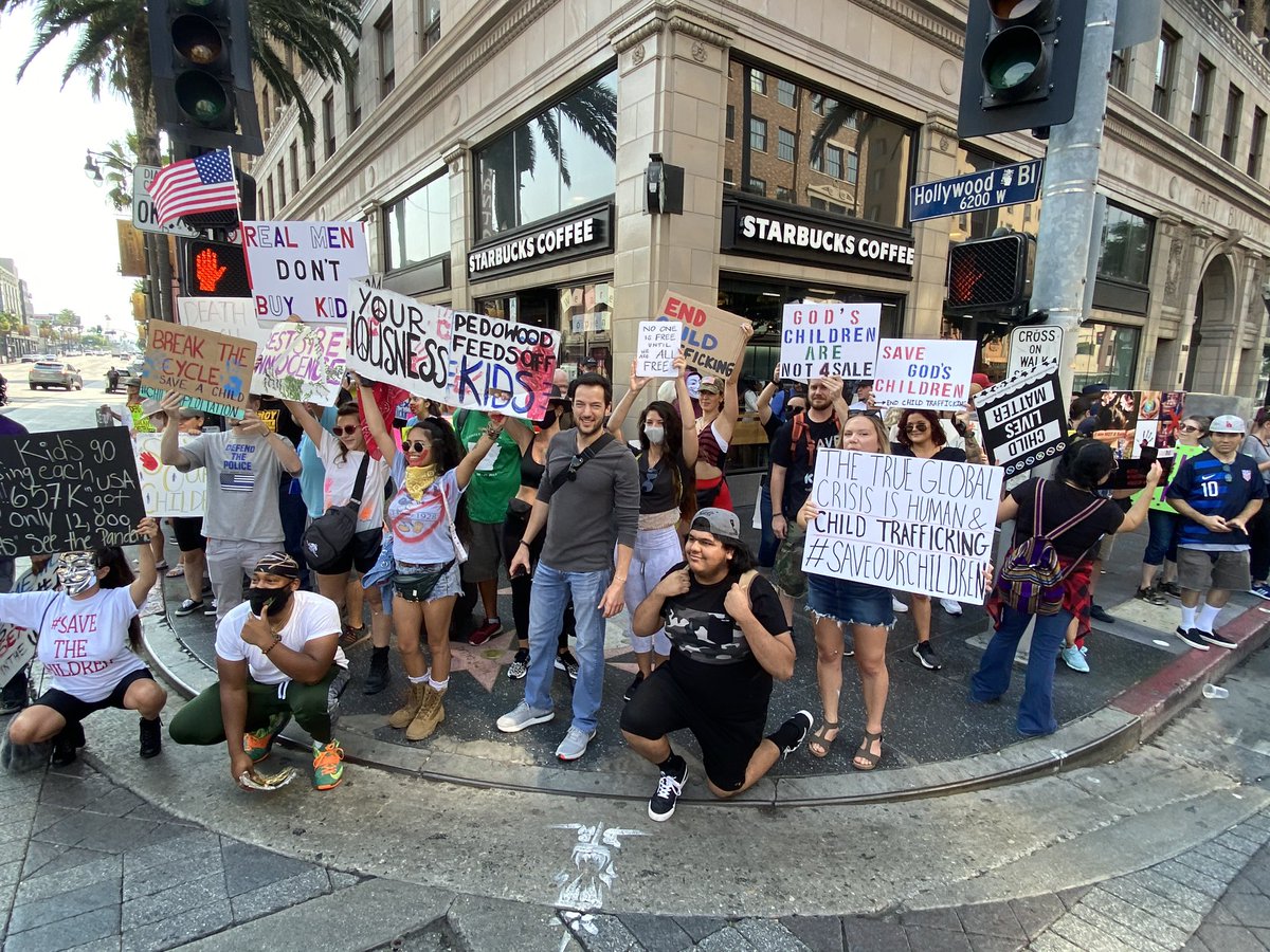 QAnon protesters are carrying signs about pizzagate, adrenochrome & frazzledrip in Hollywood while chanting, “our children are not for sale”