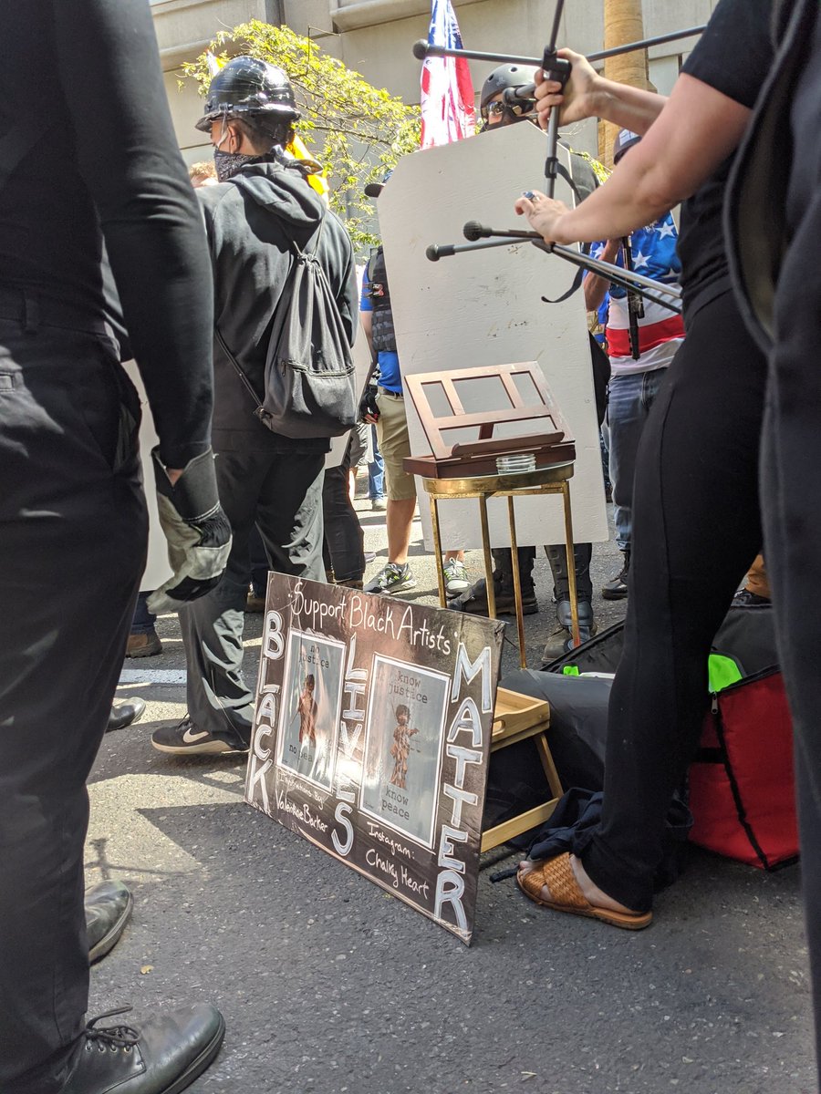 Painting station in front of blue lives matter shield line.