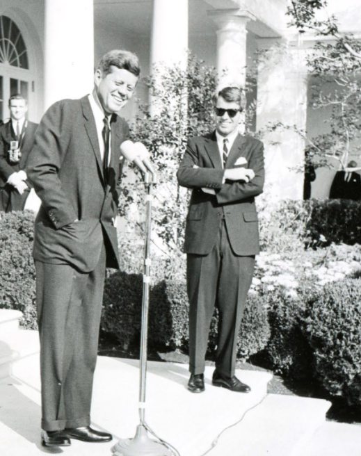 Photos of President John F. Kennedy in the Rose Garden including the iconic image of President Bill Clinton as a teenager shaking hands with President Kennedy in the Rose Garden in 1963.