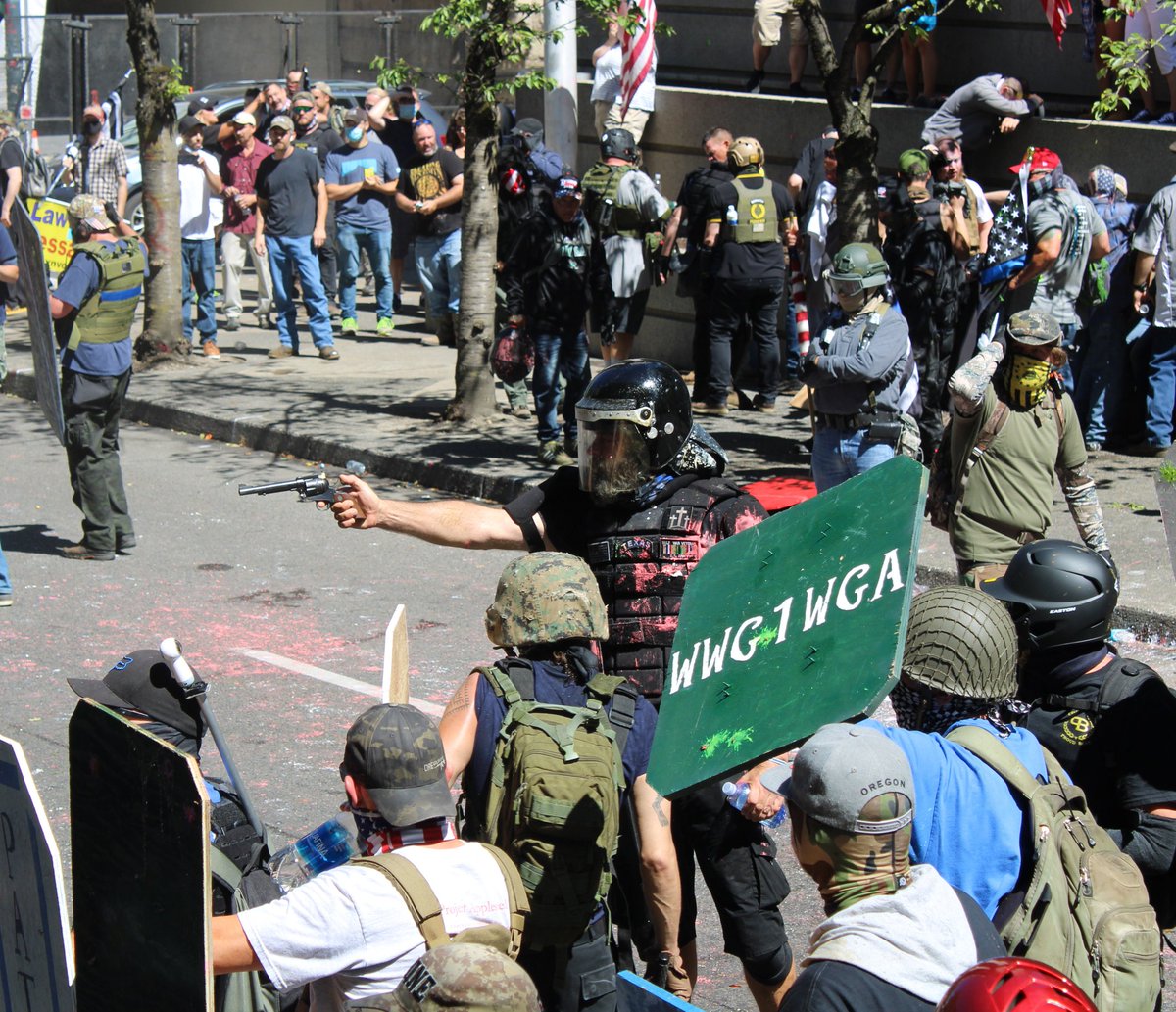Right wing protester with a cocked gun aimed at BLM protesters in Portland today.