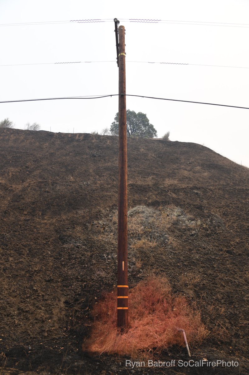 SoCalFirePhoto's tweet photo. Contractors using Phos-Chek to protect the power infrastructure during the #LNULightningComplex on the #HennesseyFire As you can see it works we saw numerous poles sprayed down that the fire didn’t even touch. https://t.co/PLqPtegwXD
