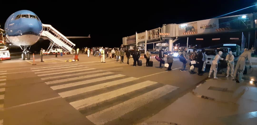 UgandaMFA's tweet photo. IN PICTURES: Arrival at Entebbe International Airport of 87 Ugandan Nationals and legal residents who were stranded in Germany, Russia, USA, UK and Canada due to the COVID- 19 pandemic
#MOFADelivers #RepatriationUG #WelcomeHomeKaribu
#StaysafeUG #COVID19UG https://t.co/1vXimvTkKA