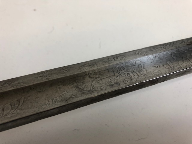 The grip (the part of the handle that you well...grip) is made of wire-wrapped fish-skin, a naturally rough surface that would have been practical as well as decorative - and the blade has these ornate engravings...including the word "Halifax!"