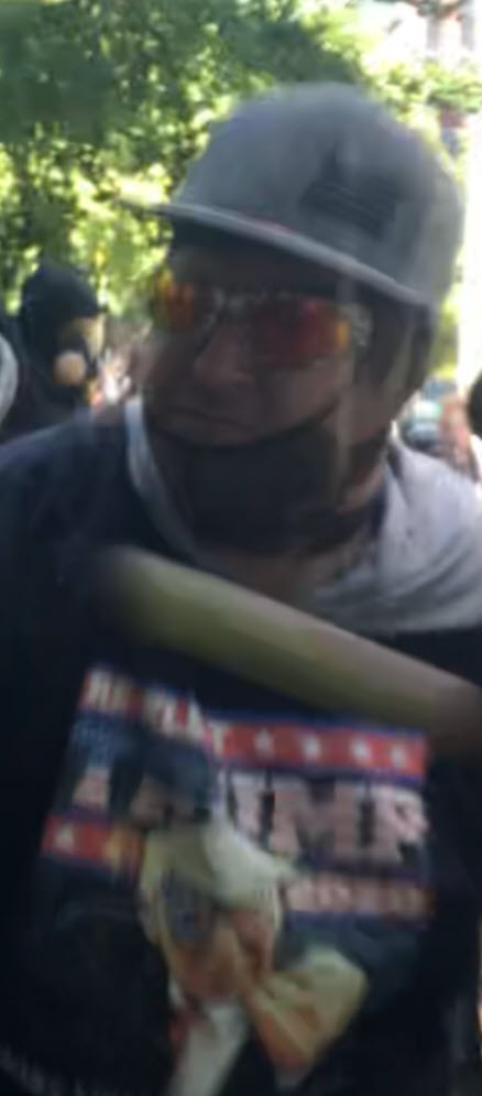 A few more photos of him, where you can see some obvious details (Trump shirt, GoPro camera, flat-brimmed USA hat with sticker still on, camo face covering, etc)