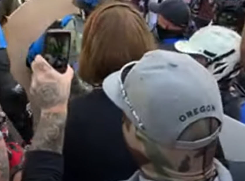 Good view here that  @gianfiorella found, showing his hat says Oregon on the back and he was either recording or streaming throughout. Note tattoos on his left hand/forearm too.(11:58 )