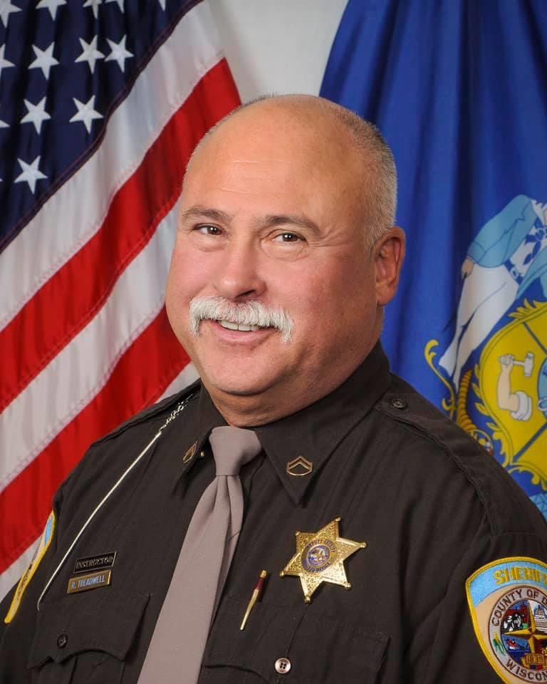 UWMadisonPolice's tweet photo. Our hearts are heavy today, as we mourn the loss of a friend and colleague from @DaneSheriff. Deputy Rick Treadwell passed away this weekend from COVID-19.

Our thoughts and prayers are with Deputy Treadwell’s family — including his law enforcement family. https://t.co/yrBHJJNksf
