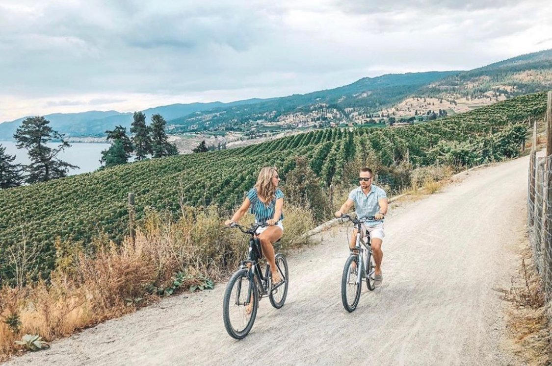 What a great way to tour around #Naramata ! Bring your own bike or rent an e-bike and tour adventure along the #KVR trail! Thanks to @PentictonNow for this photo taken by @newlyheadstravel . Happy Sunday! #OKWineFests