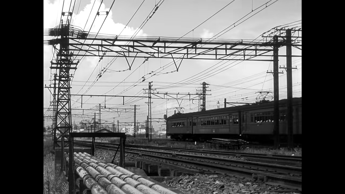 We can finally see Tokyo in the distance here as we transition out of the train sequence with a series of pillow shots.