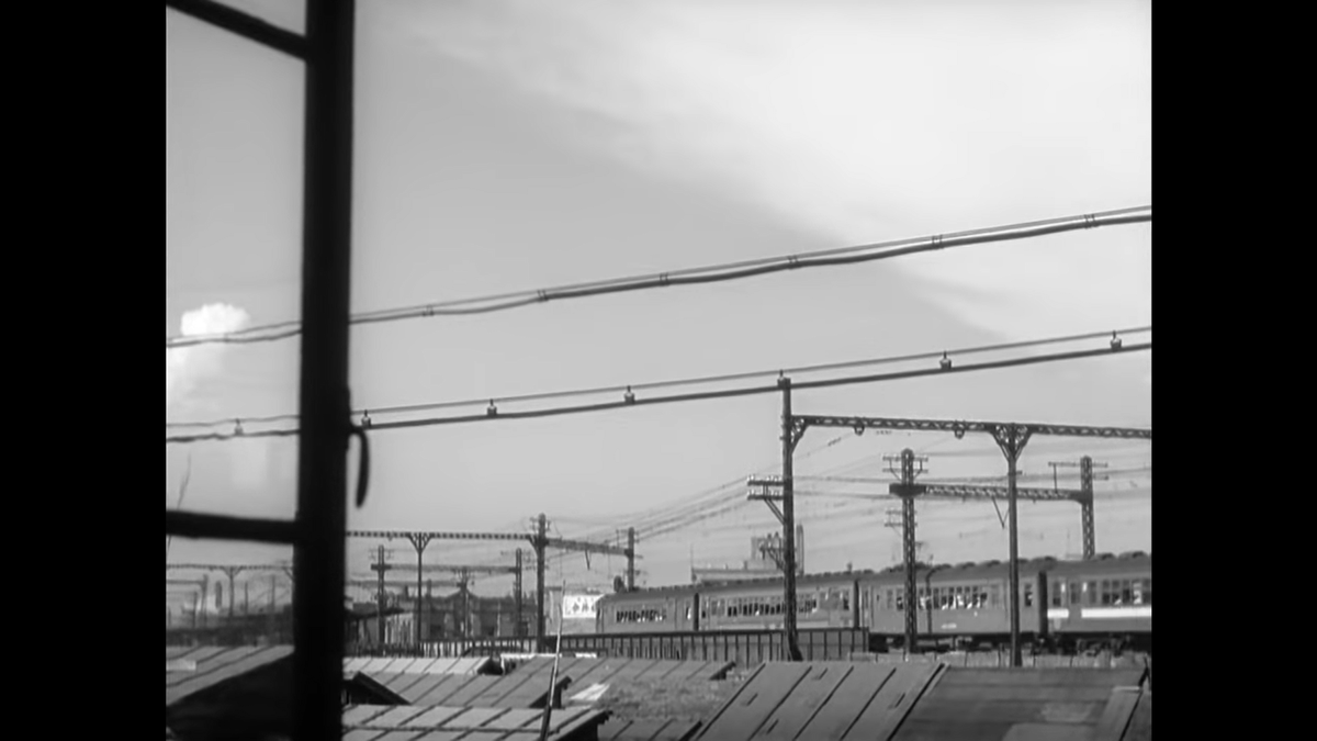 How about the window in this shot? There’s no reason for it to be there other than Ozu’s focus on a pleasing composition, particularly as it pertains to depth of field and divisions of the frame.