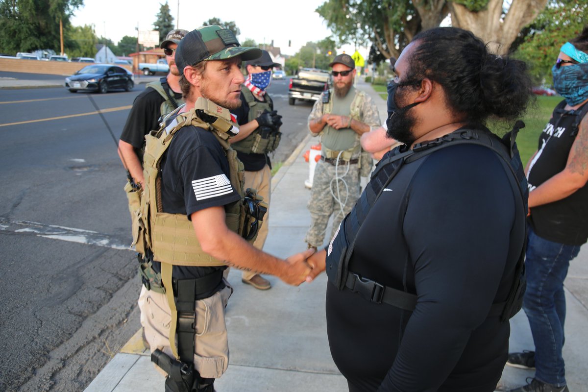 More than a dozen members of the Three Percent militia showed up with assault rifles and zip tie handcuffs. The group’s local leader, Jerrad Robison, said some people from the flag side of the street had asked them to come and keep the peace.