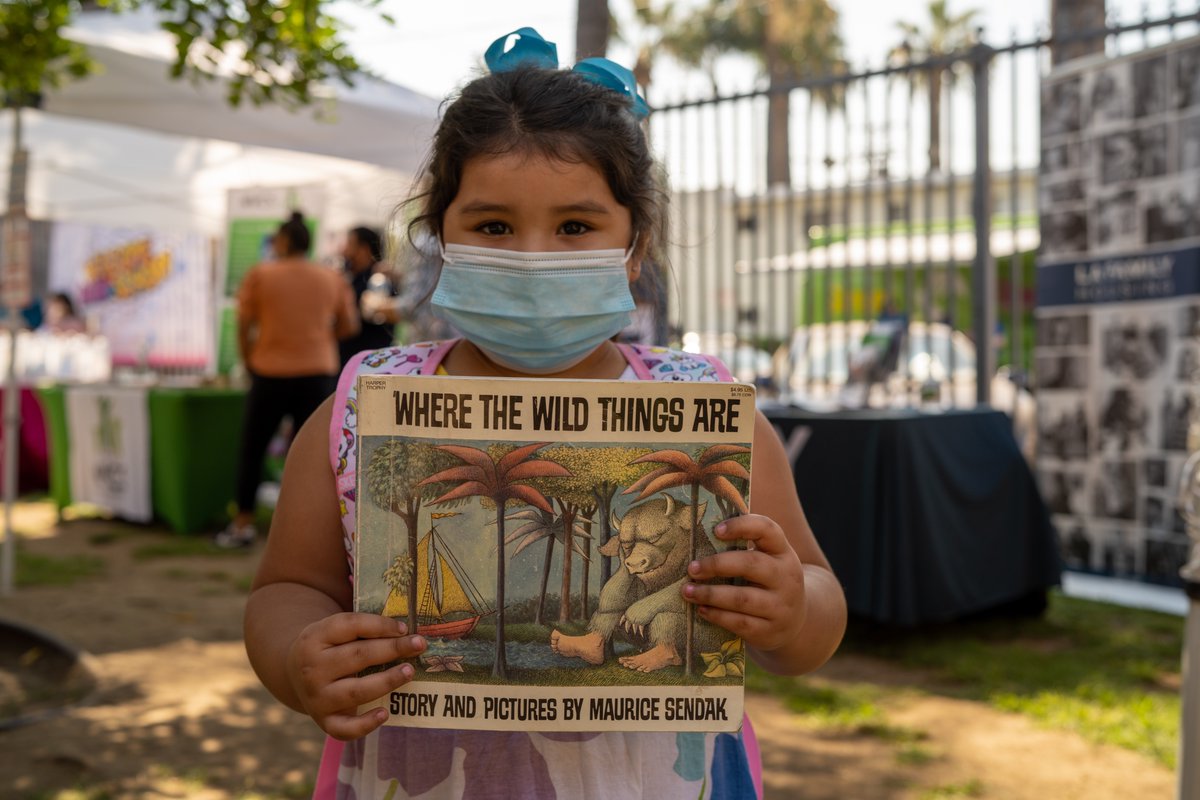 Young girl holding Where the Wild Things Are
