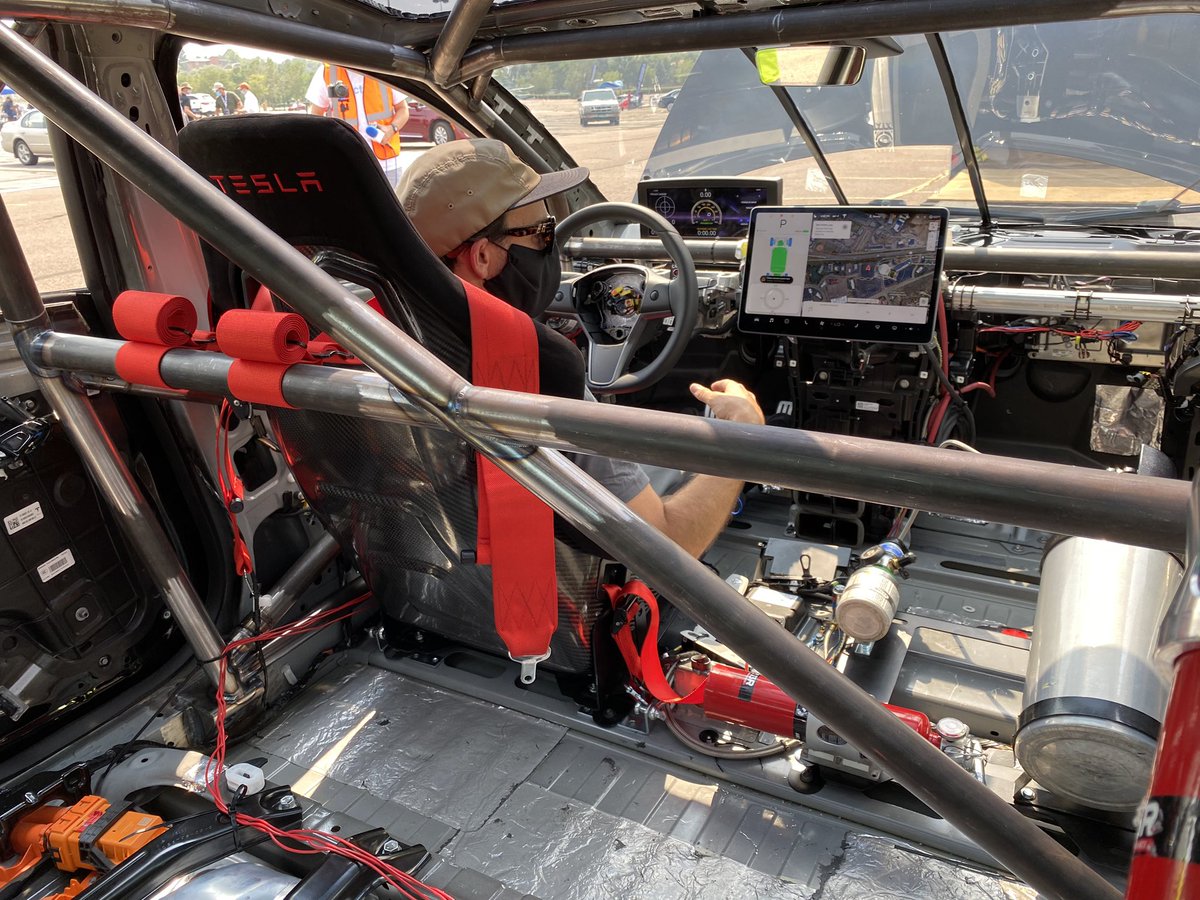 Sofiaan's tweet photo. It’s cozy in this #Tesla race car. The @UnpluggedTesla guys have to do some tricks to make the car think nothing is missing (or added) 😂 https://t.co/ZLM4vS00Mm