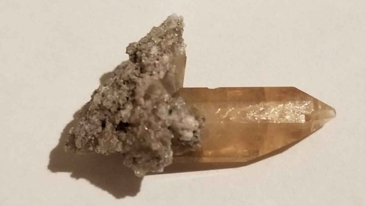 here are some topaz crystals still attached to the material found on the inside of vugsa vug is a cavity in a rock lined with mineral crystals