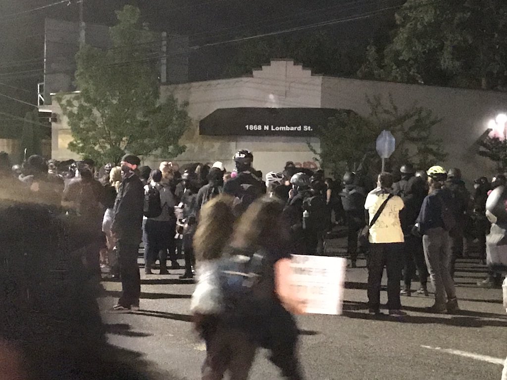 ottoiris's tweet photo. Protesters have just arrived at the Portland Police Union building in N. Portland. A small fire has started behind the building, and plywood appears to attempted to be removed from the building. https://t.co/SeJDJ3kFi0