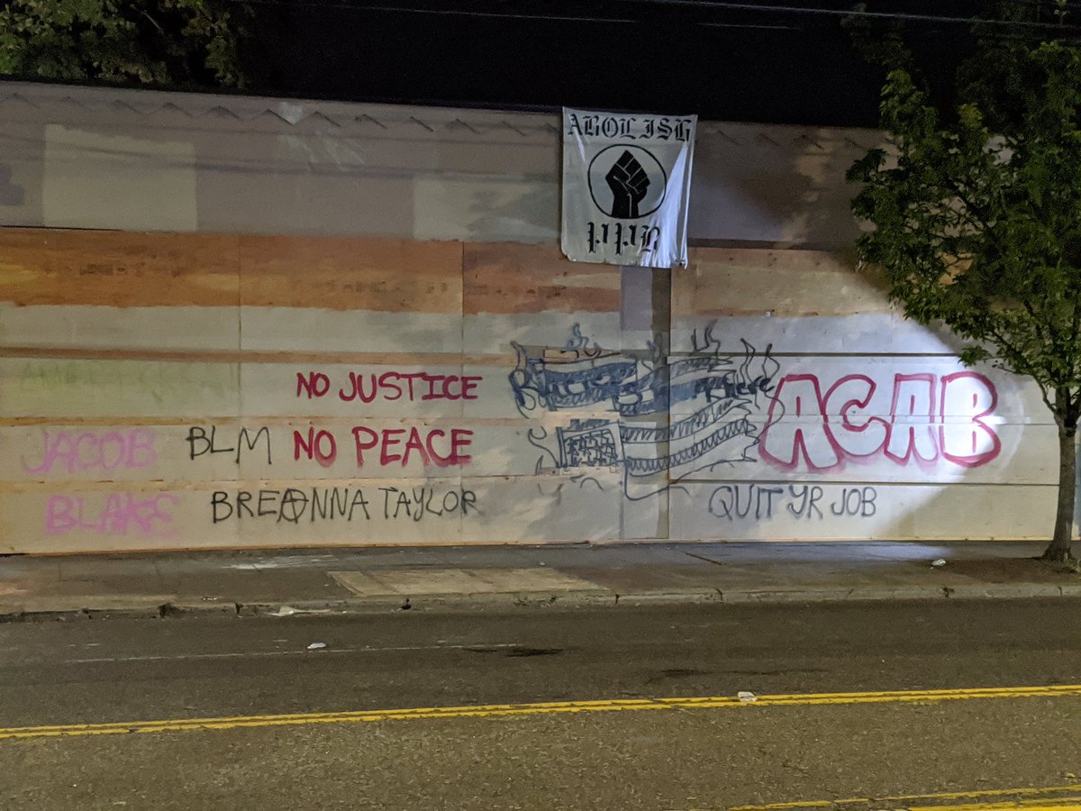 Still standing off at the PPB. One of the officers took a couple shots at the crowd known only to himThe graffiti on the PPA is very good tonight"Say her name! Kendra James! Who killed her? PPB!"