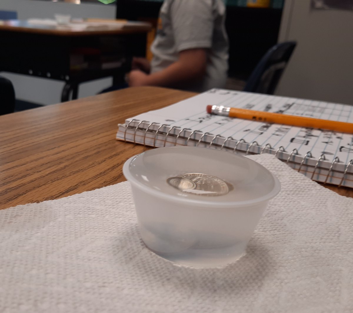 MTCESK8's tweet photo. Mr. Wirthwine is reviewing the scientific method with 5th graders. They have to make a hypothesis about what they think will happen to the water in a cup as they keep adding pennies to it. What do  you think? #SurfaceTension #mtcesSTEAM https://t.co/19BIXhoQ10