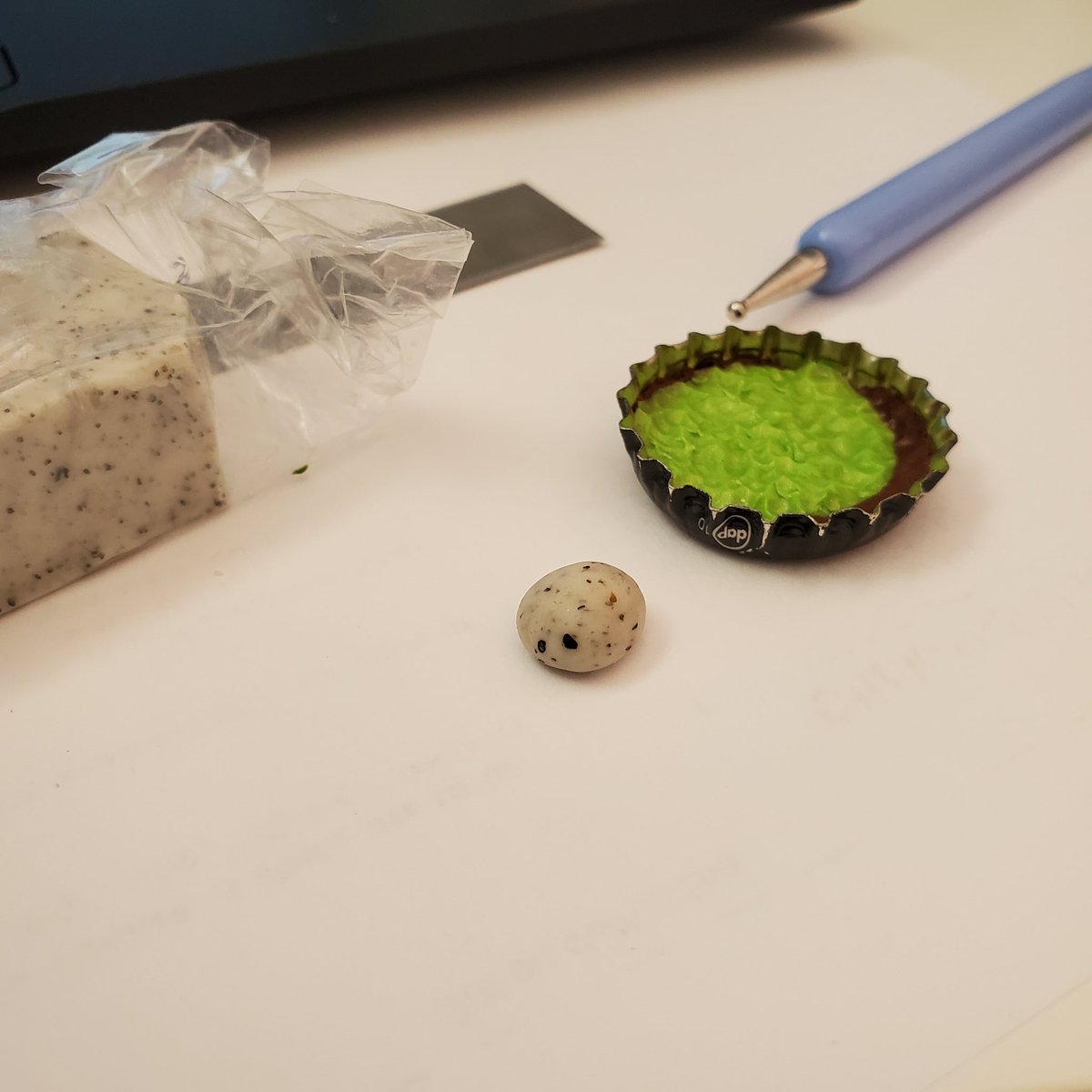Granite clay is my fave. It's so beautiful. Roll it around your fingers until you have a rock/pebble-like shape. Flatten one side against the table, then place it anywhere in your garden.