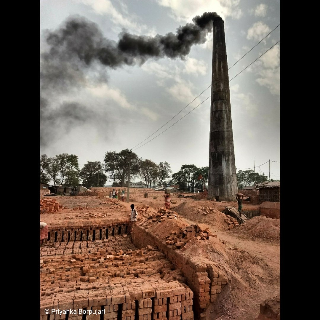 The chimney billows not just smoke from a furnace that bakes hundreds of thousands of bricks, but also the sweat and grime of the brick kiln workers who may not be able to afford a home with their meager wages.Geramari, Assam.Counting ironies on the  @outofedenwalk  #EdenWalk