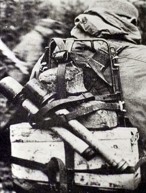 A rare image of the Tragegestell 43. A metal frame with webbing straps introduced to carry x2 Patronenkasten 34/41s on the back. A welcome, yet not widely distributed item of kit. The image dates from 1943+ & he carries a Patronenkasten 34 (300rnds max).30a)