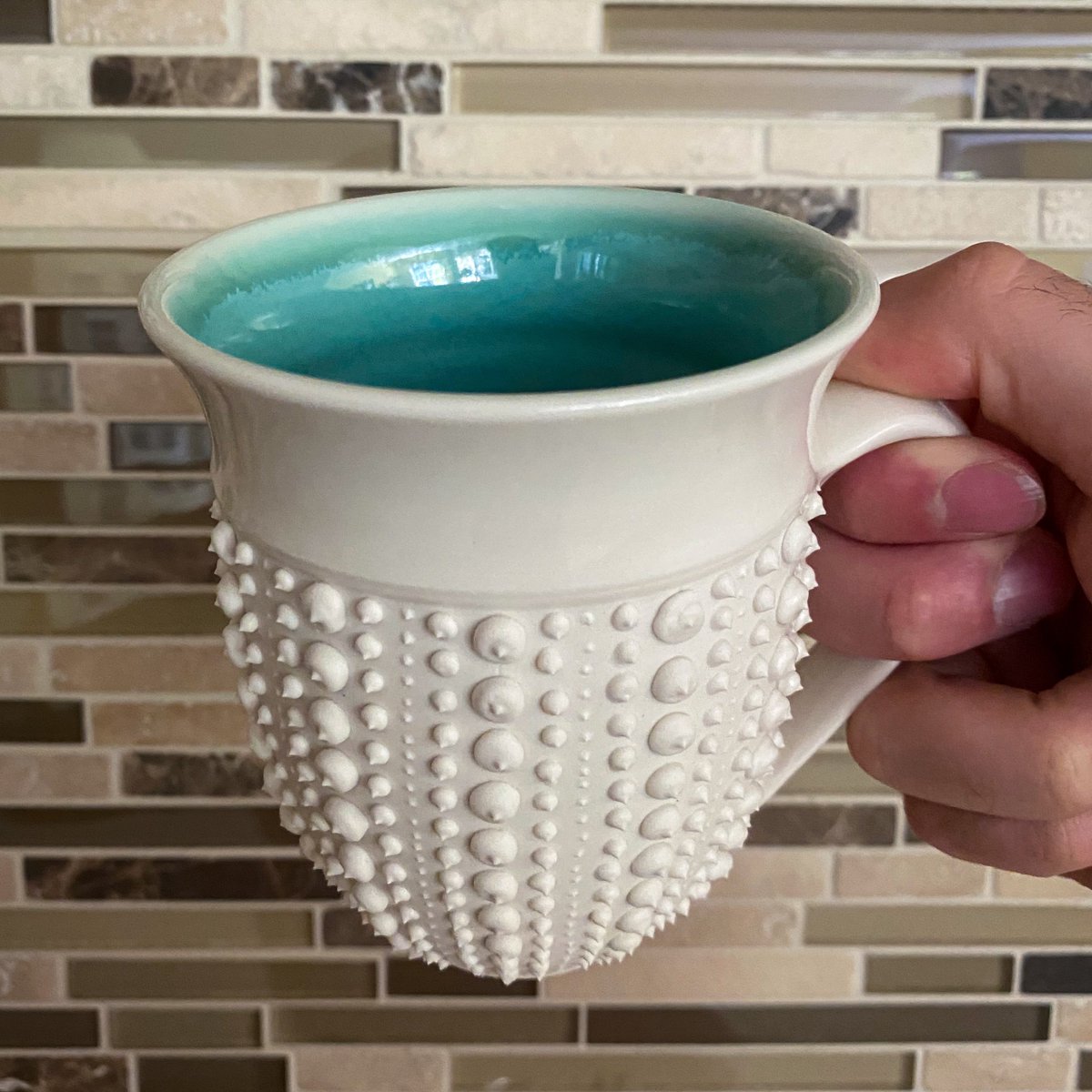 While in Asheville, NC, I came across Anja Bartels' sea urchin pottery line. I reached out to Anja and asked her if she could make a custom sea urchin mug based on other elements of her work. Here is what we came up with: