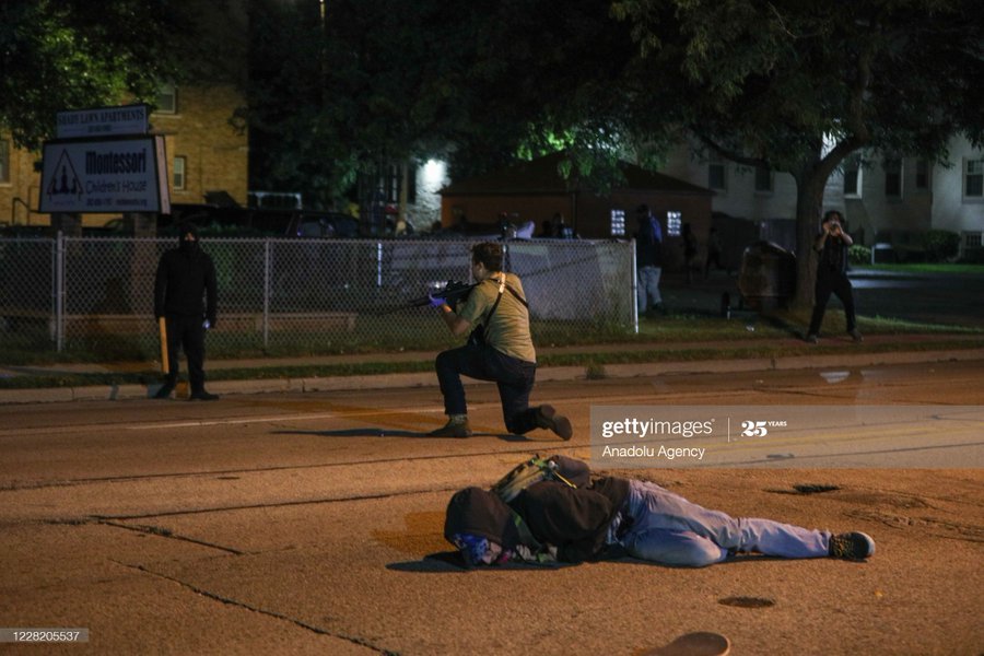 Much clearer images of Kyle on the ground. At this point he had already admitted to shooting someone (in the head) next to all those cars. People were trying to subdue a gunmen that had already shot people.