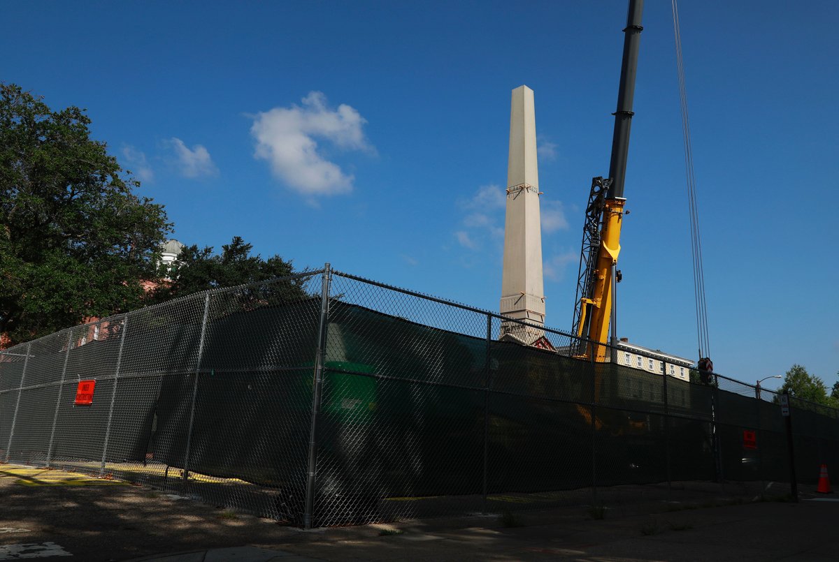 1/ A crew removed parts of the Confederate monument in downtown Portsmouth on Wednesday. The top part of the structure was down by around 10 a.m.