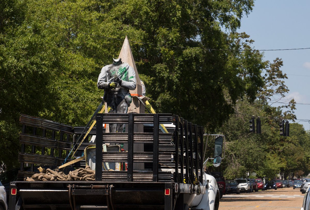 12/ By about noon on Wednesday, two of the monument’s granite statues had been taken down and loaded onto a truck.