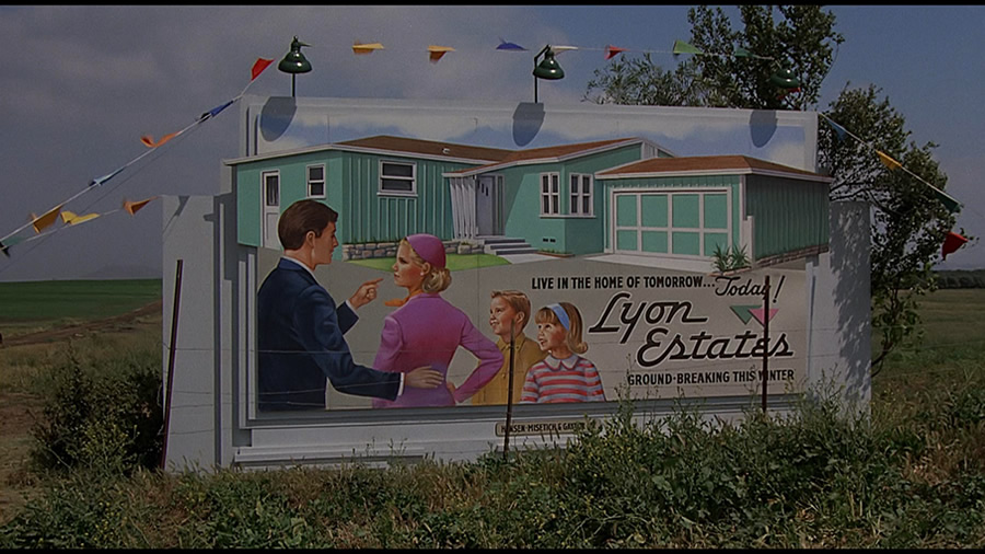 I didn't catch this in the movie as a kid but the family on the billboard is all white. The suburbs were a tool of segregation. Lenders would not give loans to Black families & many deeds were written to forbid non-white occupants of suburb homes. 