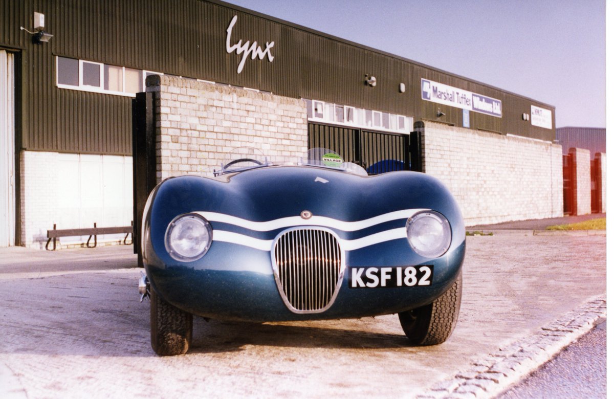 A #LynxMotors #CType race car stands purposely outside the factory resplendent in dark blue with white racing stripes. Find out more about our range of bespoke classic vehicles hand built in England lynxmotors.uk