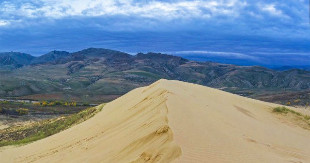  Sarykum is the largest dune not only in Russia, but throughout Eurasia. The uniqueness of the dune is that it’s not located in the desert, but rather surrounded by green steppe and year-round snowy mountains.