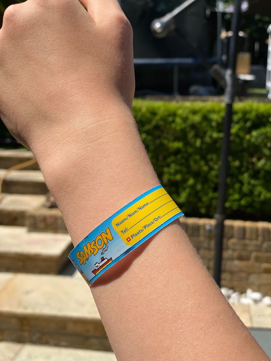childs wrist with what3words safety wristband wrapped around it