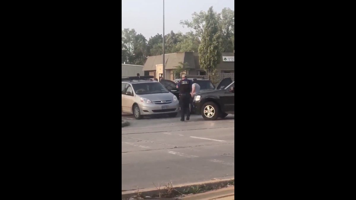 One plainclothes Special Operation Group (SOG) operator in a black hood yanks the lock out of the car door.Look at his physique.No doubt he's SOG.