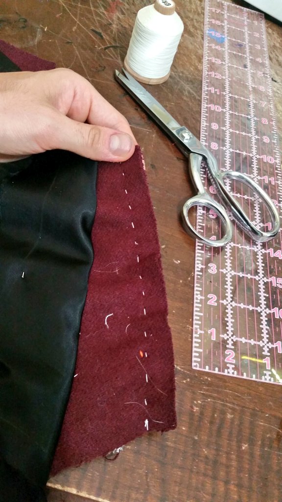 Back at it with the shoulder seams. First the front edge gets a reinforcement strip of "slight bias" (wtf) lining basted on. Notice the back is a bit bigger than the front? This gets eased in with basting stitches, then steamed until it shrinks down and those ripples dissappear