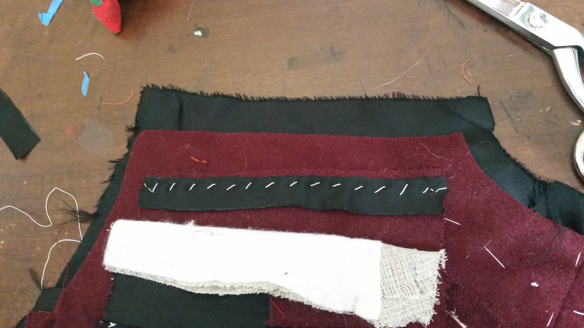 Back at it with the shoulder seams. First the front edge gets a reinforcement strip of "slight bias" (wtf) lining basted on. Notice the back is a bit bigger than the front? This gets eased in with basting stitches, then steamed until it shrinks down and those ripples dissappear