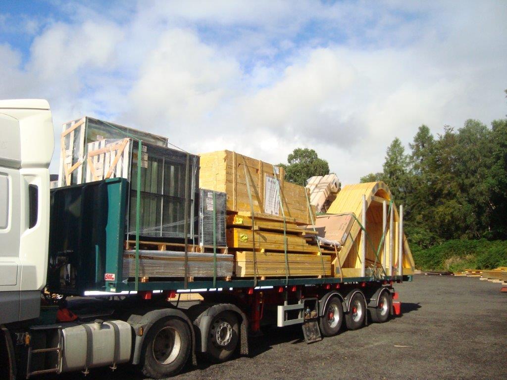Delivery all loaded up and heading out to the Isle of Coll. Note the top of the attic trusses are faceted for a curved roof. With glulam feature trusses and black alu clad timber windows by NorDan 😀#KingdomTimber #EwenStewartandsons