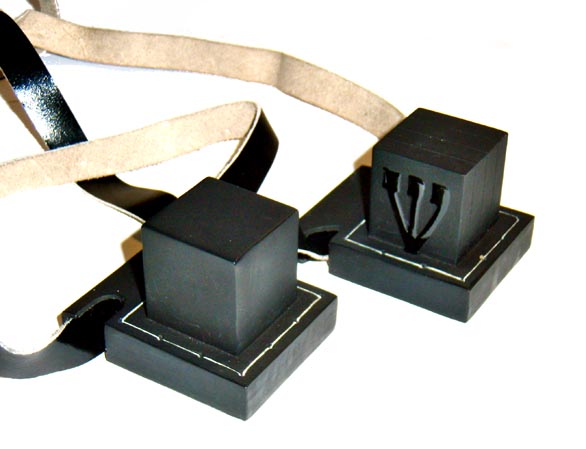 If you've genuinely never seen tefillin before, here is what they look like. One is worn on the forehead, the other on the nondominant arm (from bicep to fingers). THIS is the "arm wrapping with religious writings" that D&D originally understood a phylactery to be.