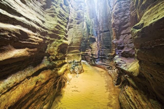 The Awhum waterfallIt is 30 metres high and is located in udi LGA,Enugu state, Nigeria.The locals believe the water has healing powers and is capable of driving away evil spirits if used. The Awhum Waterfall is also a popular tourist location in Nigeria