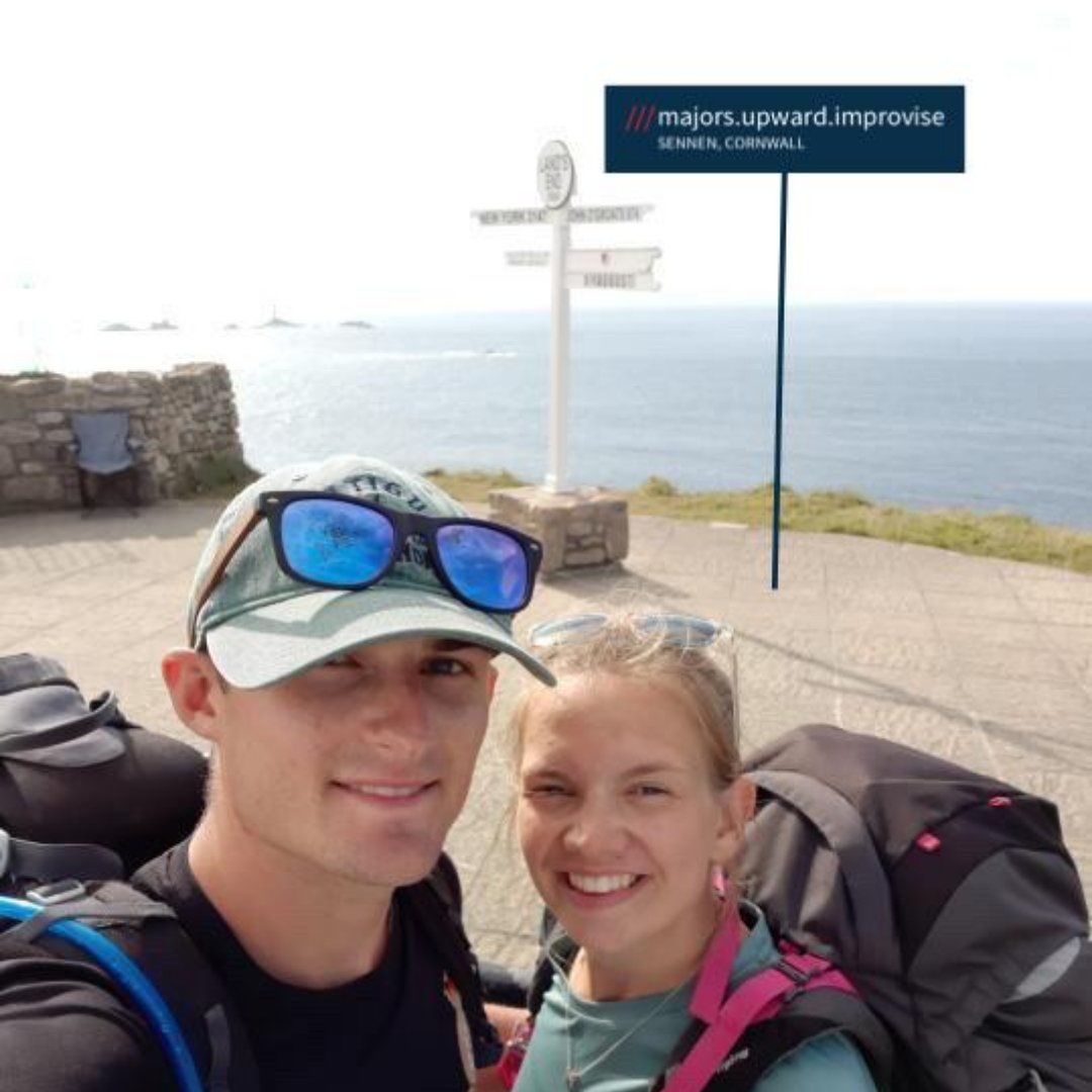 Two hikers with backpacks at ///majors.upward.improvise