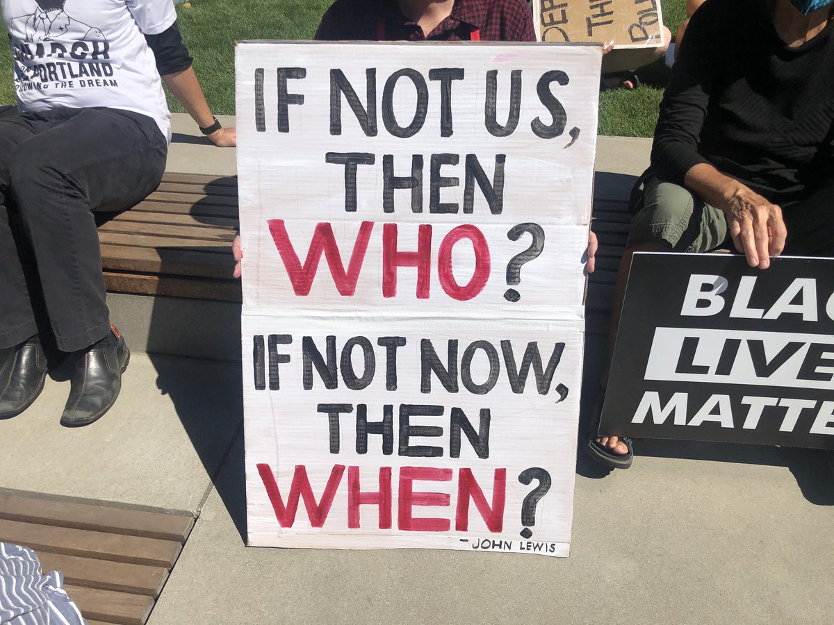 Here are some signs among the crowd: “HERE TO AMPLIFY BLACK VOICES”“IF NOT US, THEN WHO? IF NOT NOW, THEN WHEN?” “BLUE IS NOT A SKIN COLOR”“TRANS QUEER YOUNG OLD / BLACK LIVES MATTER”