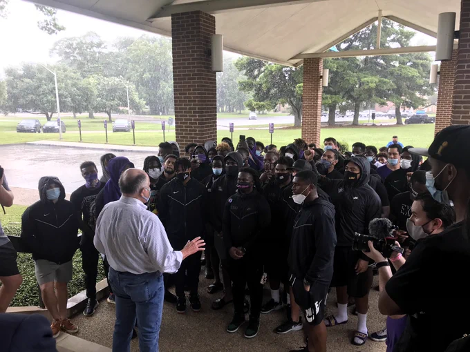 President Galligan stands outside the university administration building and address the football players who marched to the building to talk with the president.