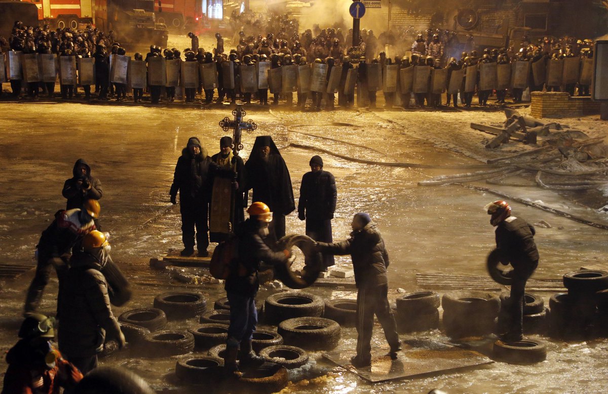 Orthodox priests standing in the middle of violent protests completely unabated isn't a photo genre I knew I needed to see
