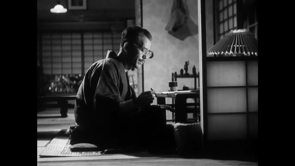 Our first night shot as we transition from the restaurant back to the Somiya house, where Shukichi is back at his desk reading the paper.