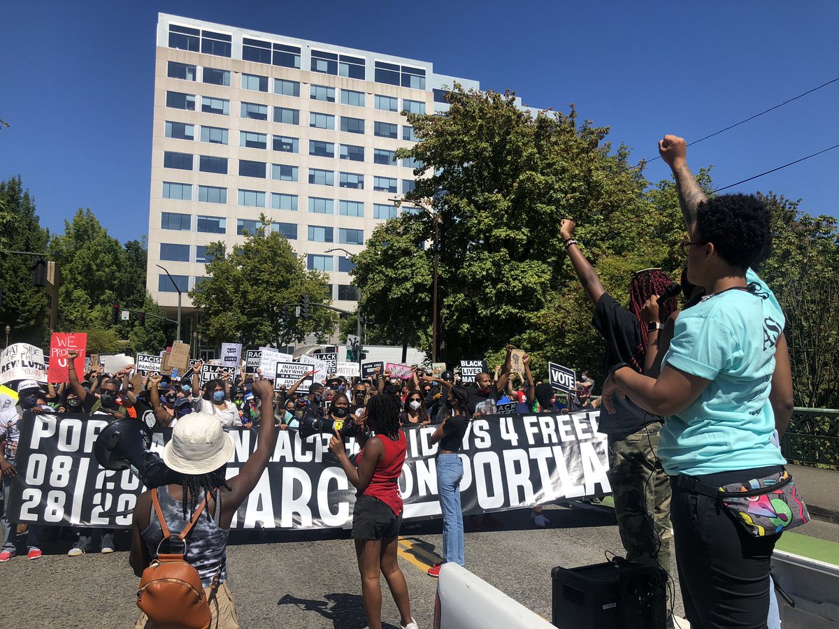 Marchers are crossing the overpass onto NE Irving St. A Fridays 4 Freedom speaker addresses the crowd: “Please do not interact with the police. If you interact with them, you are putting Black lives in danger. We are here for Black liberation. Please don’t interact with them.”