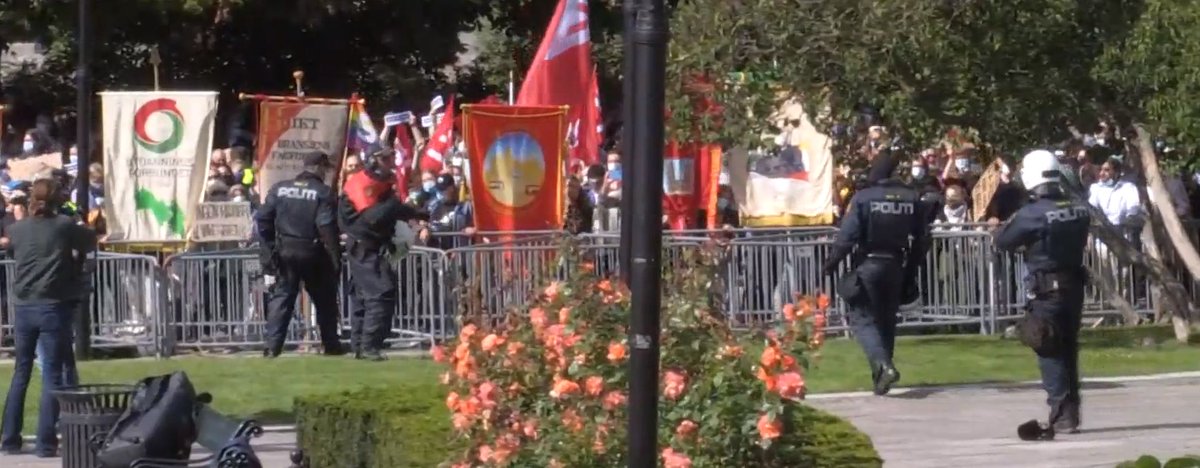 Crowds of people are "shaking the fence". Seems like they are trying to breach the security perimeter.