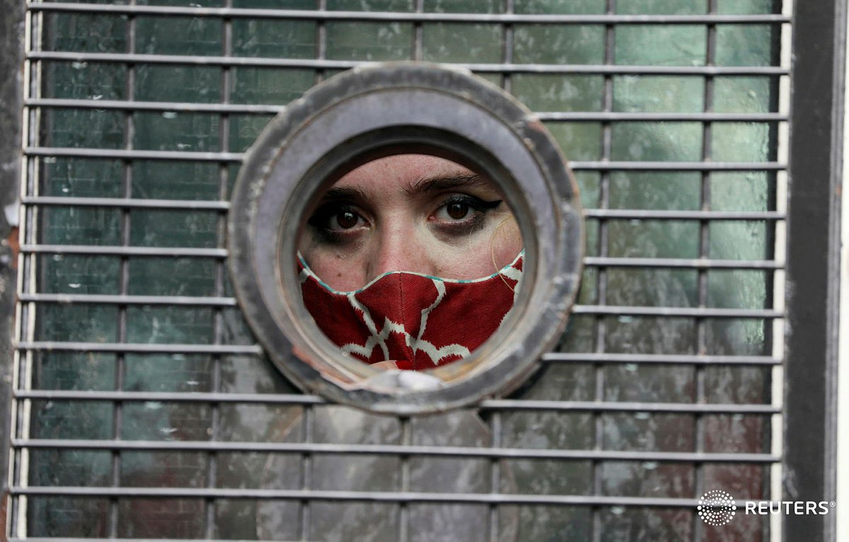 Cropperboyce's tweet photo. A woman is seen through the window of a police van after being detained during a protest against gender based violence outside the parliament in Cape Town, South Africa, August 29, 2020 https://t.co/VK2ppmlz0H