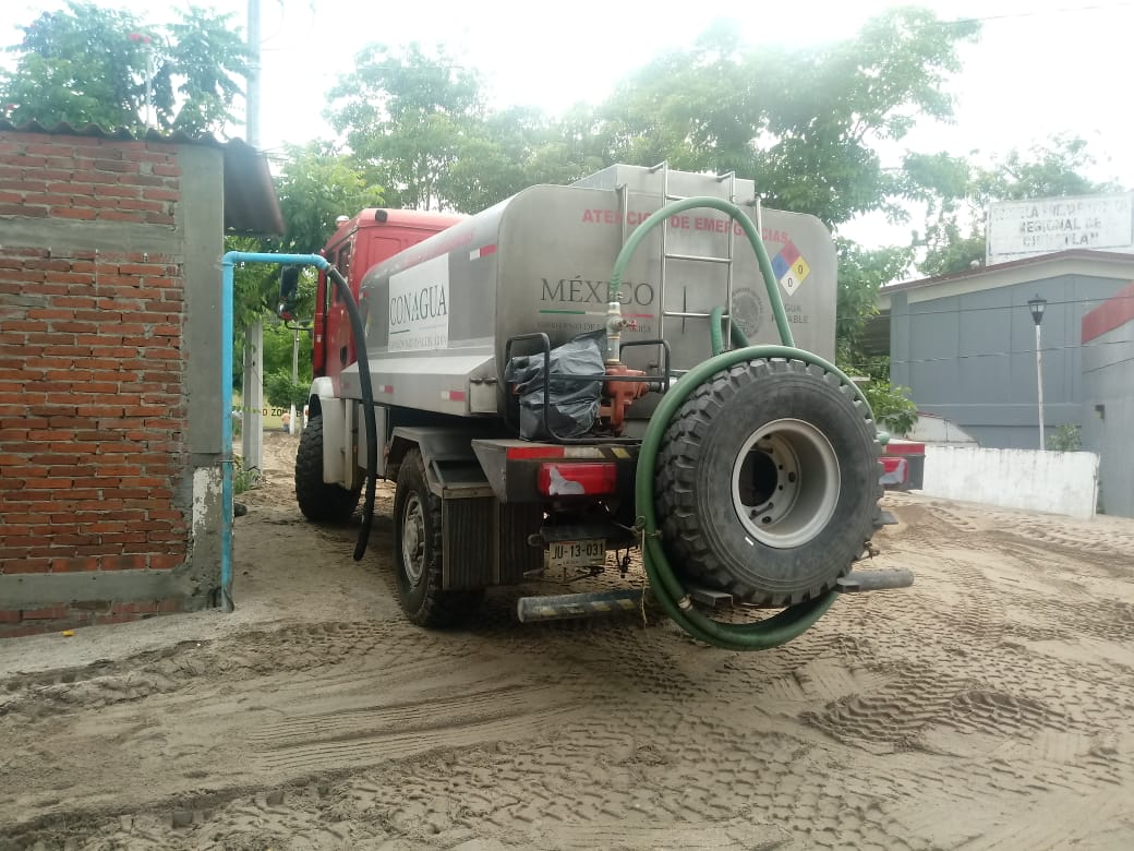 conagua_mx's tweet photo. La Brigada #PIAE del Organismo de Cuenca Lerma Santiago Pacífico #OCLSP, de la #Conagua, apoya a la población con el desazolve de la red de drenaje en Cihuatlán, #Jalisco. Además, distribuye #Agua potable a los afectados por la #TormentaTropical #Hernan https://t.co/qUdNBv8XNg