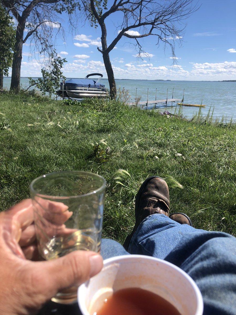 Perks of owning a ranch on the lake. Take a lunch break from pickin bales  and enjoy a beer and juice, tequila, and this view!