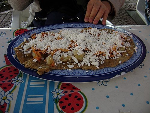 A sope made on a large, fried, oblong tortilla is called a huarache. These hold a lot more toppings and really need to be eaten with a fork and knife. A stuffed huarache is called a tlacoyo, and these are smaller.