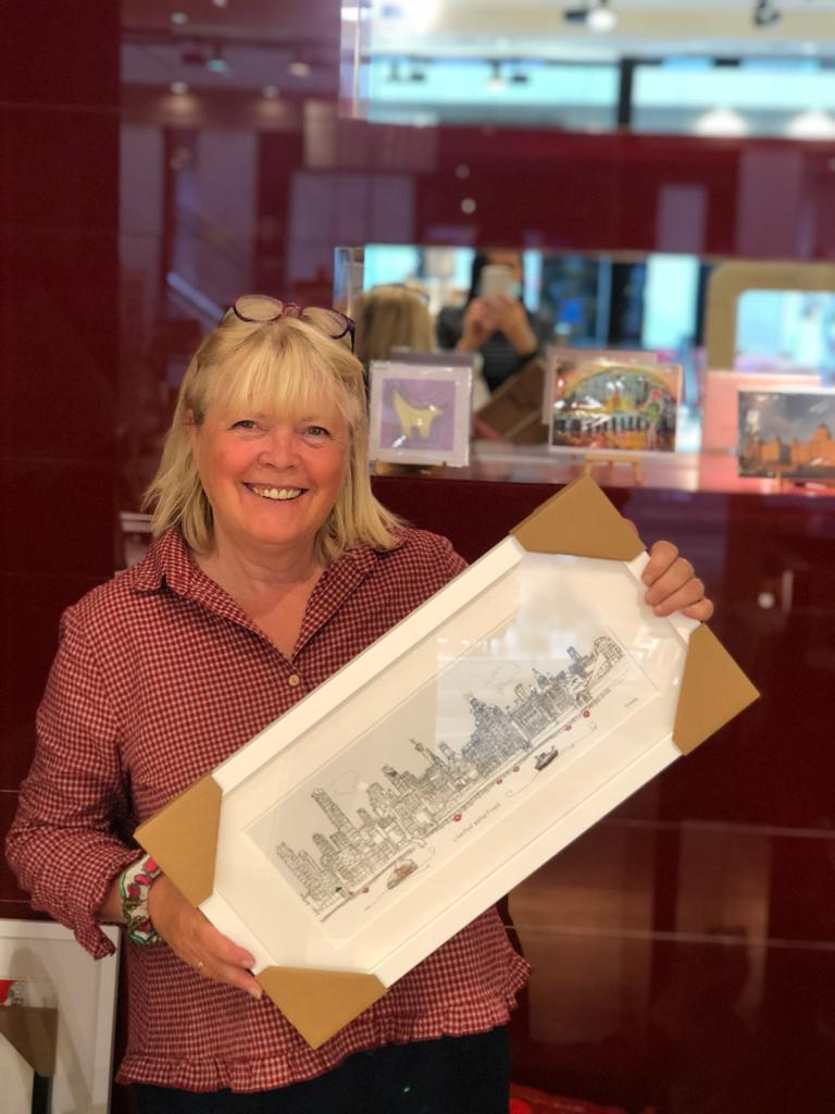 A very happy customer walked away with Freida McKitrick’s framed fine art print of the Liverpool waterfront today. Here’s a lovely photo of our one &amp; only Freida 💜 
#wehavethebestcustomers #meettheartist
